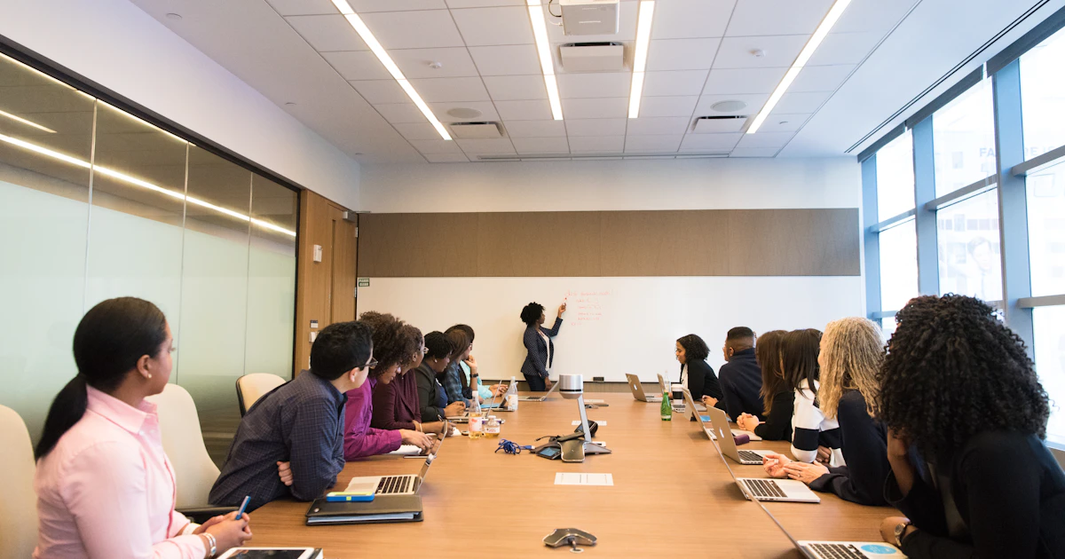 People seated at a conference table during a board meeting