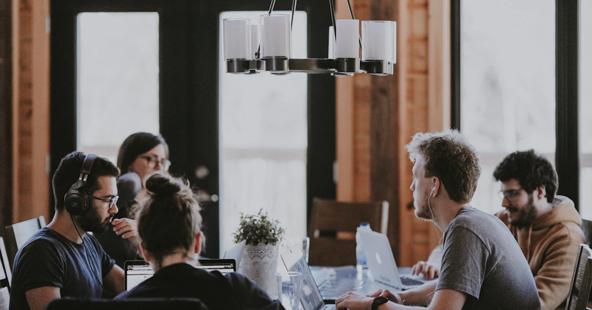 A group of people seated around a conference table during a meeting